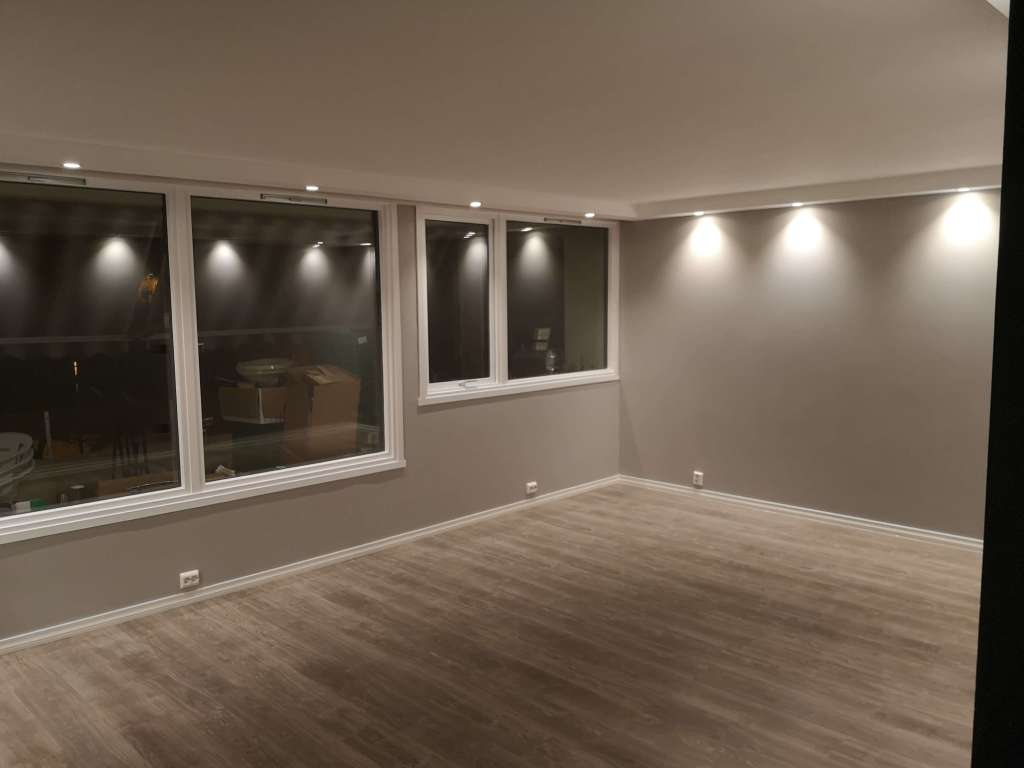 Image of a renovated apartment with grey walls and big windows