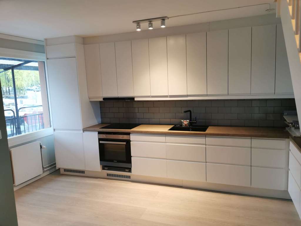 Image of a renovated kitchen with white cabinets