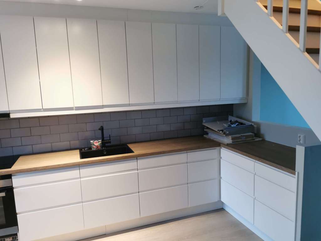 Image of a renovated kitchen with white cabinets