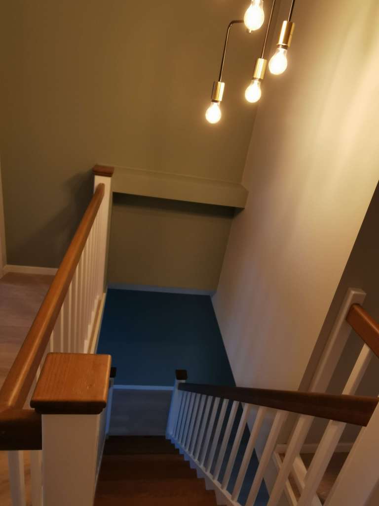 Image of a renovated room and a stair