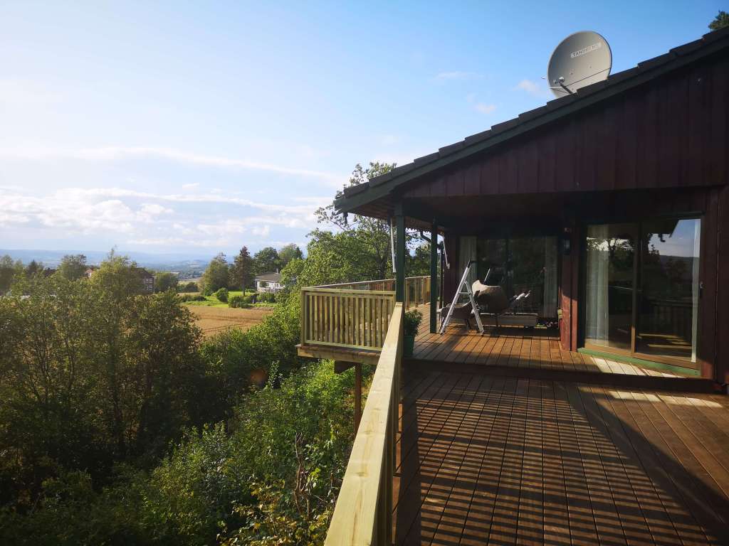 Image of a terrace, wooden railing and secured fence