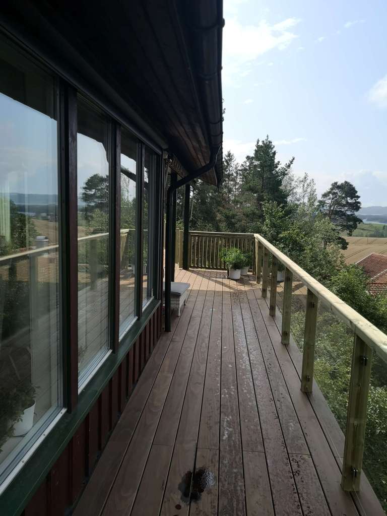 Image of a terrace, wooden railing and secured fence