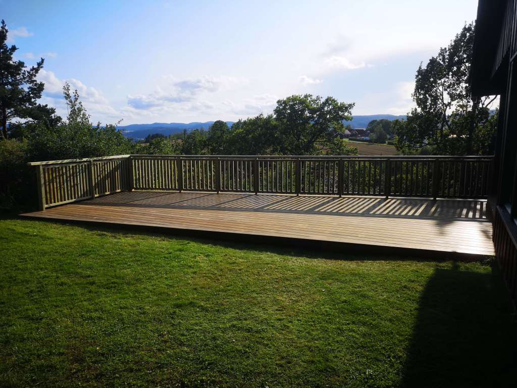 Image of a terrace, wooden railing and secured fence