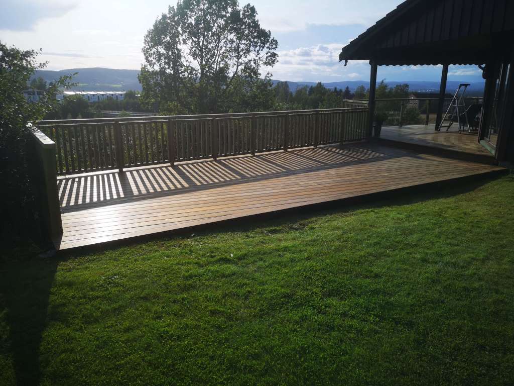 Image of a terrace, wooden railing and secured fence